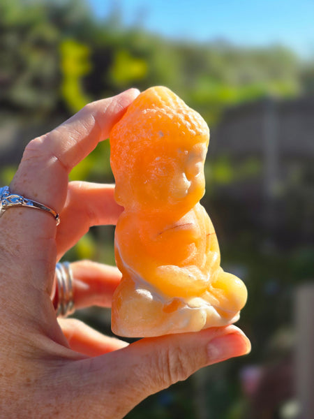 Orange calcite buddha
