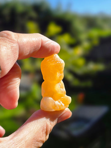 Orange calcite buddha