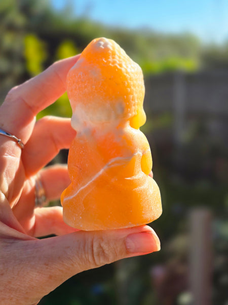 Orange calcite buddha