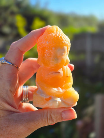 Orange calcite buddha